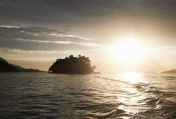 Image showing Sunset, nature and sea with landscape and horizon, environment for travel and vacation location. Clouds, sky and water with tourism destination, natural background or seascape with waves and calm