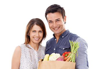 Image showing Happy couple, portrait and shopping bag with groceries for food, natural sustainability or nutrition on a white studio background. Young man and woman with smile for healthy vegetables or ingredients