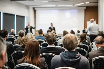 Image showing I have a question. Group of business people sitting in conference hall. Businessman raising his arm. Conference and Presentation. Business and Entrepreneurship