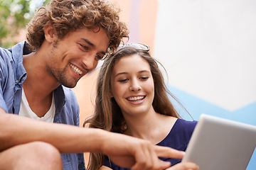 Image showing Happy students, together and studying with tablet connectivity, teamwork and education in university. Young people, man and woman work with technology in collaboration, concentrate and sit on campus
