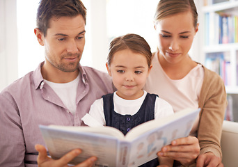 Image showing Parents, child and reading at home, sofa and child development in home schooling and bonding. Mom, dad and toddler on couch, living room and smile while learning in book and fairytale stories