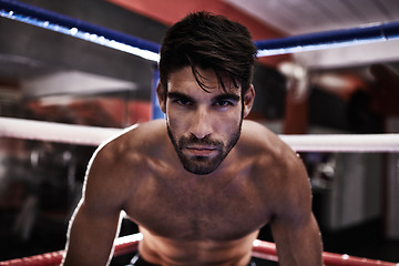 Image showing Fighter, determined and man ready in ring for challenge, competition and training for strength in gym. Male person, healthy and fitness from practice in exercise studio as athlete of sport and MMA