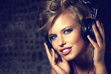 Image showing Happy, portrait and woman with headphones for music, streaming and listening to radio in dark. Techno, sound and face of musician mixing track and relax with trippy audio for entertainment in home