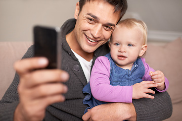 Image showing Happy family, father and baby with selfie in home, love and care of new parent in living room. Dad, daughter and smile with cellphone for profile picture, cute and bonding together on sofa in house