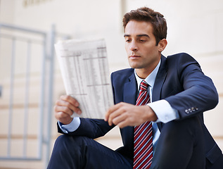 Image showing Employee, reading and newspaper for stock information for company in business for career. Man, thoughtful and working as worker of corporate and professional for accounting job in suit outdoor