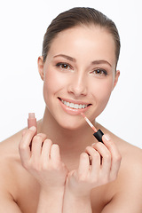 Image showing Woman, lipstick and makeup in portrait for shine, beauty with gloss and cosmetology on white background. Hands, face and cosmetic product for lips, change or transformation in studio with wellness