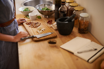 Image showing Cooking, woman and hands in a home with dinner, nutrition and healthy food with salad with knife. Kitchen, bowl and leaves for organic and vegan lunch with diet and wood board in house with wellness