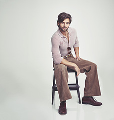 Image showing Man, vintage and clothes for fashion, studio and handsome with retro aesthetic, handsome and portrait. Male person, chair and backdrop or background and model with sunglasses, luxury and funky