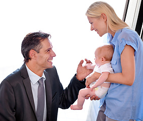 Image showing Love, father and greeting mother and baby after a long day at work. Happy businessman, excited and smile or bonding with family or relax together at home with parents and child with affection