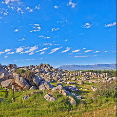 Image showing Mountains, rocks and clouds in blue sky for travel, hiking and eco friendly tourism or explore with beautiful view. Background of landscape, environment and field in summer by countryside with mockup