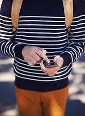 Image showing Hands, phone and man in outdoors for website, student and scrolling on university app or internet. Closeup, male person and typing a message or check email, online and communication or social media