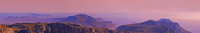 Image showing Mountains, landscape and pink sky with background for travel, hiking or eco friendly tourism and banner of Cape Town. Aerial view of sunset, nature and sea or ocean on the horizon in South Africa