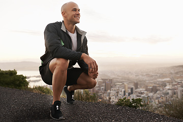 Image showing Happy man, mountain and fitness with view of city for workout, exercise or training in nature. Young male person or athlete with smile for running, break or rest on road, street or outdoor cliff