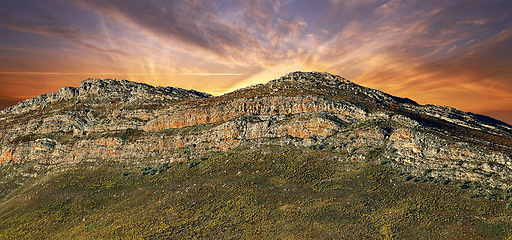 Image showing Mountain, landscape and sky at sunrise with rock, texture or countryside in Africa like heaven. Morning, outdoor and banner of hill on horizon with aerial view of bush environment with grass on stone