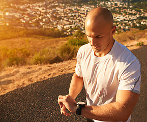 Image showing Man, fitness and checking time with watch on mountain, road or street for workout or exercise. Male person looking at wristwatch for monitoring performance, outdoor training or health and wellness