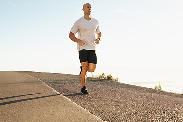 Image showing Man, running outdoor and fitness in street, cardio and health in park with fresh air and training for marathon. Sports, exercise with athlete or runner with workout, wellness and endurance in city