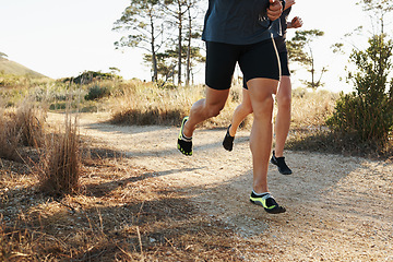 Image showing Closeup, people and legs with running for fitness, exercise or outdoor training on dirt road. Person and runner with sports shoes or footwear for hiking, trekking or cardio workout together in nature