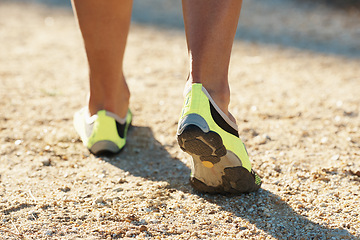 Image showing Person, runner and athlete with shoes for running, marathon or sports on dirt road or terrain. Closeup of athletic feet, footwear or getting ready for cardio, training or outdoor exercise and workout