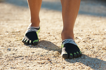 Image showing Person, runner and athlete with footwear for running, marathon or sports on dirt road or terrain. Closeup of athletic feet, shoes or getting ready for cardio, training or outdoor exercise and workout