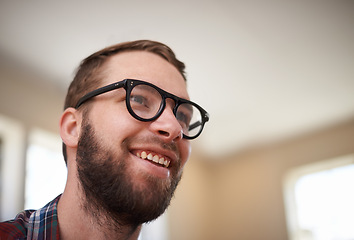 Image showing Man, laughing and happy with humor in home, satisfaction and cheerful in living room. Male person, comic and relax in apartment or confident with funny joke, smile and pride for silly or goofy comedy