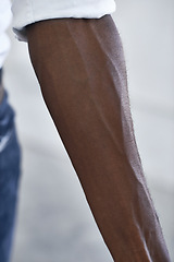 Image showing Strong, arm and person with vein from muscle and shirt, fashion or closeup in white background. African, skincare and forearm of model with healthy fitness, wellness or muscular bodybuilder in office