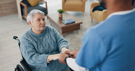 Image showing Wheelchair, sad or old woman holding hands with nurse for support or consultation for healthcare service. Stress, trust or sick elderly patient with disability in nursing with caregiver or retirement