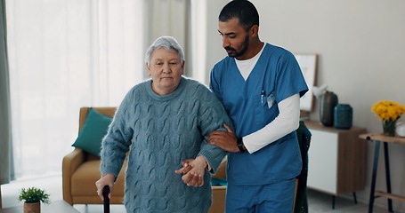 Image showing Senior woman, nurse and walking stick for support at nursing home in retirement. Elderly female patient with disability and caregiver man for rehabilitation, healthcare and help for healing injury