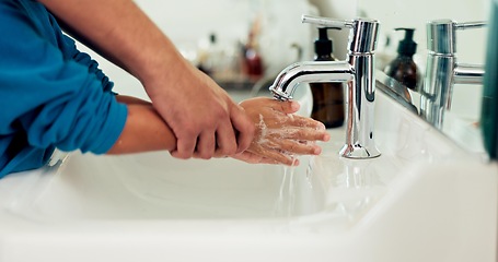 Image showing Hands, washing and parent helping kid for hygiene and health, water and child development for wellness. People in bathroom, clean with soap at sink and healthy, learn handwashing and disinfect