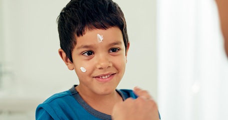 Image showing Boy, skincare and cream with morning routine and sunscreen with cosmetics. Happy, kid and moisturizer with youth in a family home and bathroom with lotion, cheerful and facial care with wellness