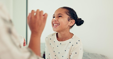 Image showing Young child, skincare and laugh for lotion, smile and morning hygiene for wellness. Cream, girl and moisturizer with youth, family and home in bathroom, sunscreen and facial care and cosmetics