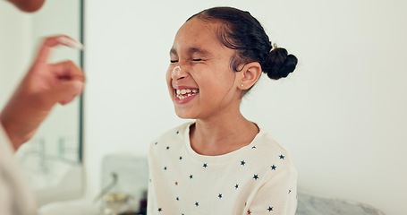 Image showing Young child, skincare laugh and lotion with smile, morning and hygiene and wellness. Cream, girl and moisturizer with youth, family home and bathroom with sunscreen and facial care and cosmetics