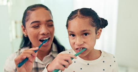 Image showing Brushing teeth, mother and daughter with toothbrush, portrait and dental for health, morning routine and happy. Bathroom, home and hygiene with mama, girl and oral care with cleaning mouth and child