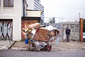 Image showing Garbage, cart and trash in street outdoor for waste management, recycling and man cleaning in neighborhood. Community, scrap and boxes of junk material in sao paulo with person collecting old litter