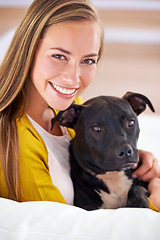 Image showing Woman, dog and happy in living room in portrait, smile for pet love and bonding at home with domestic canine. Relax, positive and trust with foster or adoption, pitbull puppy and animal care on couch