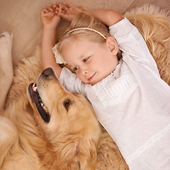 Image showing Dog, child and mat on floor for animal, pet and relax together indoor for bonding, affection and friendship. Puppy, girl and smile with golden retriever for love, adorable and companion at home