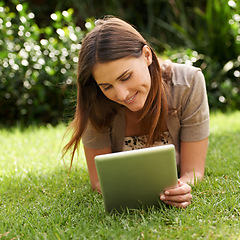 Image showing Tablet, smile and woman outdoor on grass, nature and garden for communication, technology and internet. Happy female person, backyard and digital pad for social media, connectivity and browsing