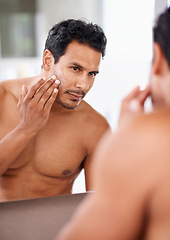 Image showing Skincare, cosmetics and mirror with man in bathroom for morning routine, facial treatment and moisturizer. Self care, confidence and face of male person for sunscreen, lotion or cream in reflection.