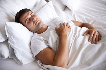 Image showing Male person, sleep and bed for peace, wellness and happy for rest in white top and bedroom for home and happy. Man, relax and dreaming at house, calm and tired after day at work and taking nap