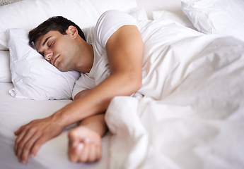 Image showing Man, sleep and bed for peace, wellness and home for rest in pajamas and bedroom for relaxing and sleepwear. Male person, relax and dreaming at house, calm and tired after busy day and taking nap