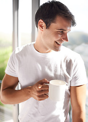 Image showing Man, mug and smile with coffee by window in bedroom, apartment and hotel room for morning time, waking up and new day. Male person, adult and happiness for tea, espresso and cappuccino in Spain