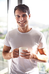 Image showing Portrait, man and smile with coffee by window in bedroom, apartment and hotel room for morning time, waking up and new day. Male person, adult and happiness for tea, espresso and cappuccino