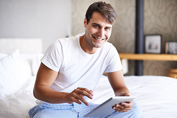 Image showing Man, tablet and pajamas for morning, routine and book in bedroom for wellness and digital for class. Male person, hobby and student for relaxation, leisure and reading for home free time in house