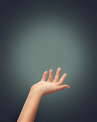 Image showing Hands, help and person reaching in studio for hope, charity or guidance, care or trust on dark background space. Palm, offer and model with mockup for donation, safety or assistance, guide or support