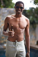 Image showing Man, sunglasses and shirtless with beer in summer for relax, celebration and weekend drinks by swimming pool. African person, face and topless with smile, alcohol or holiday fun on vacation at resort