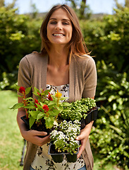 Image showing Woman, smile and flowers for gardening and plant in environment outdoor with sunshine. Gardener and happy person with shrub and bloom for sustainability, growth and earth for lawn or park