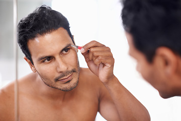 Image showing Eyebrow, hair removal and tweezers of man for maintenance, grooming and self care in bathroom mirror. Cosmetology, skincare and male person for facial treatment, brows shape and morning routine.