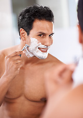 Image showing Man, hair removal and shaving cream on face in bathroom mirror for razor blade, grooming and beauty. Skincare, wellness and male person for self care, morning routine or hygiene with reflection.