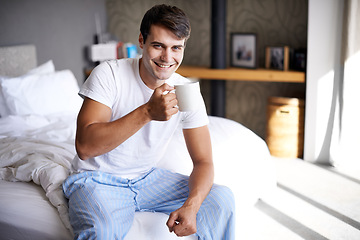 Image showing Man, bedroom and morning coffee portrait and smile, weekend off in apartment to relax with attractive male person. Casual and holiday or home, Saturday off day and comfortable positive guy with cup