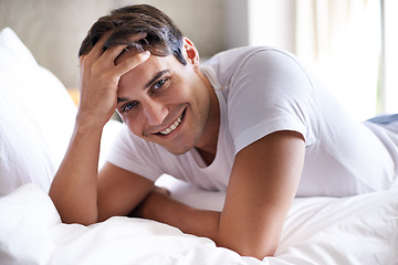 Image showing Man, bed and smile in morning to relax, holiday and vacation in bedroom. Happy, day off and comfortable attractive male person, casual and rest for weekend break in apartment for waking up on sheet