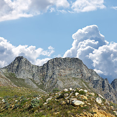Image showing Mountain, blue sky and scenery with clouds, travel location and journey in natural landscape. Nature, landmark and environment for outdoor adventure, explore and holiday destination in Cape Town.